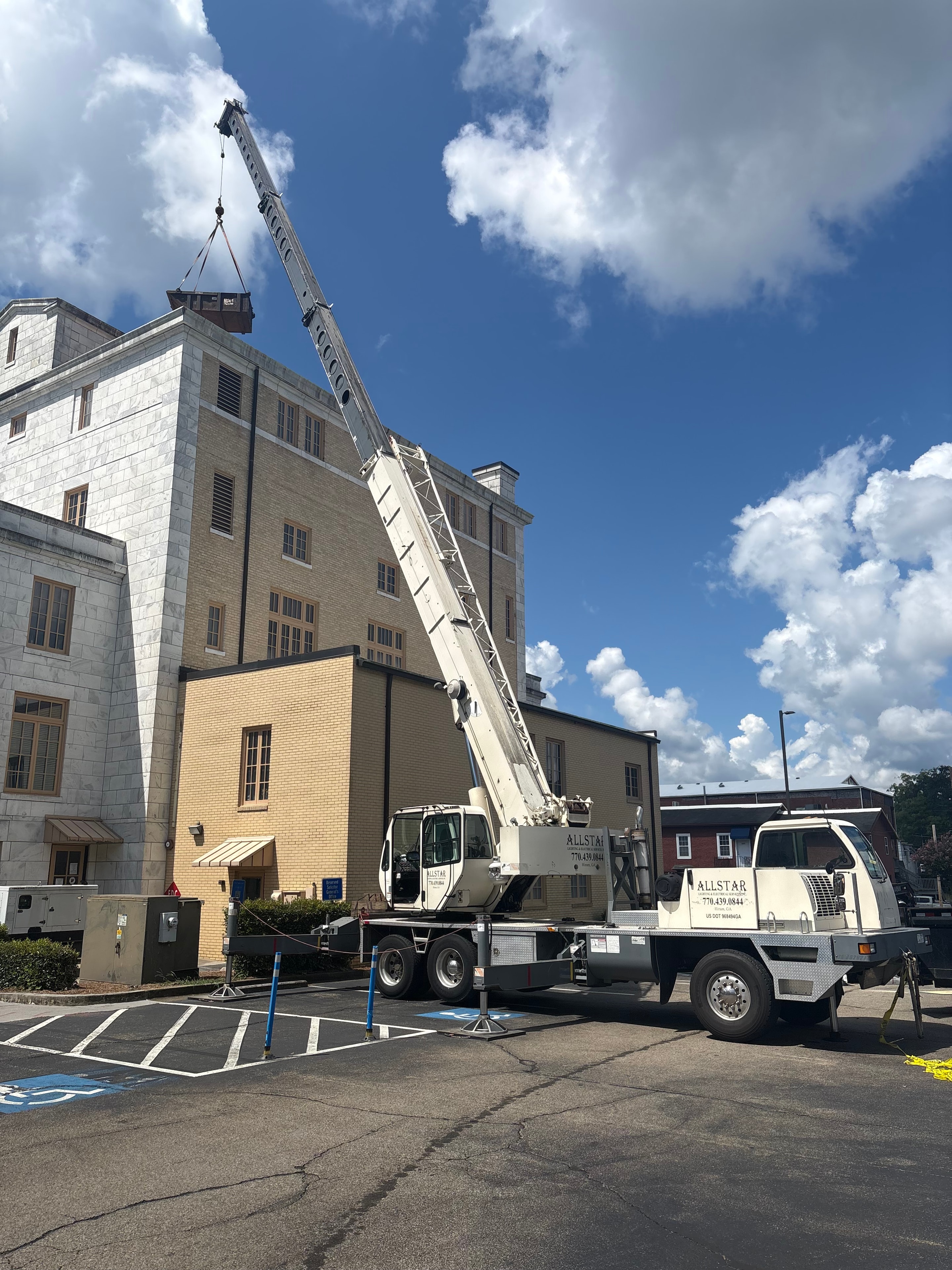 Allstar Lighting crane truck extended at commercial building